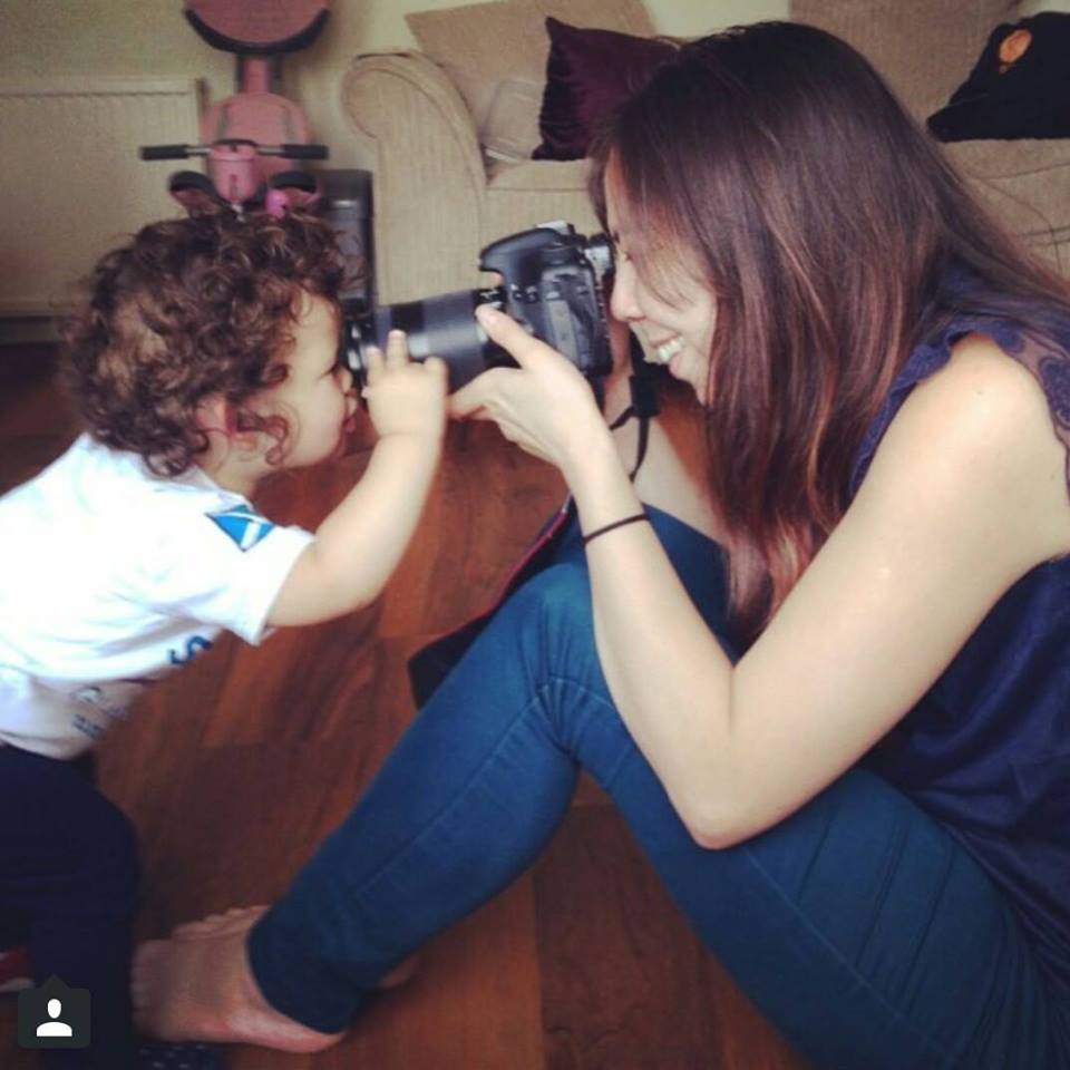 Image of Jo Foo taking photos of an inquisitive toddler